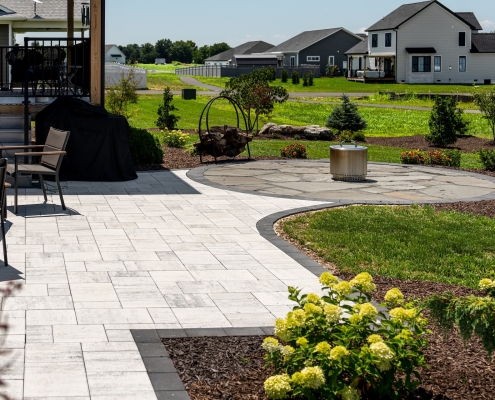 Shreckhise_McGraw_After-10 A view of a home's back patio with landscaping and hardscaping.